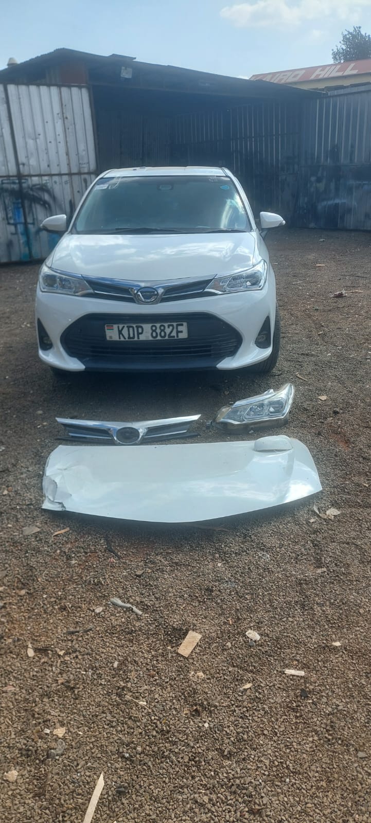 Toyota Axio KDP 882F with replaced grille, headlight and bonnet