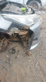 Close-up of damaged bumper and engine bay